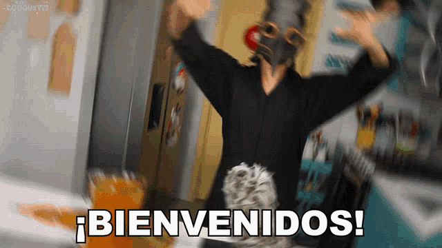 a man wearing a gas mask is standing in front of a sign that says bienvenidos