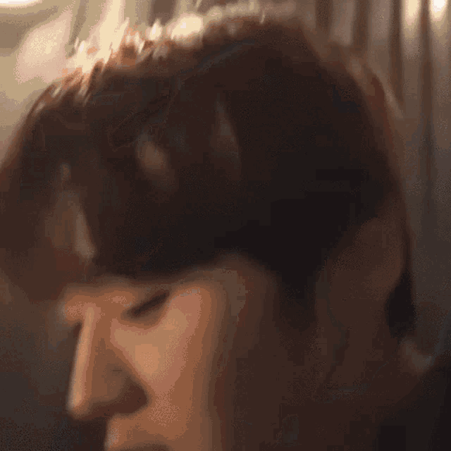 a close up of a person 's face with their mouth open and their eyes closed .
