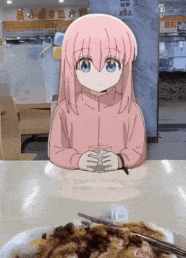 a pink haired anime girl is sitting at a table with a plate of food