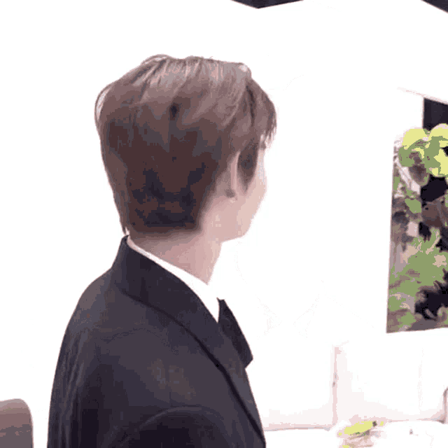 a young man in a suit and tie is making a face .