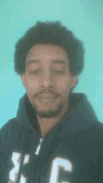 a man in a hoodie with the letter c on it