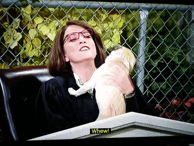 a woman holding a dog with a sign that says " when "