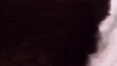 a close up of a person 's face with a blurry background .