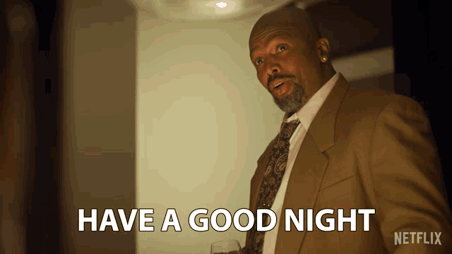 a man in a suit and tie says have a good night on a netflix screen