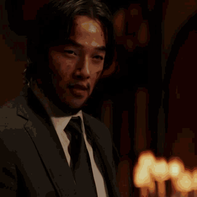 a man sits at a table with a bottle of wine and a plate of food