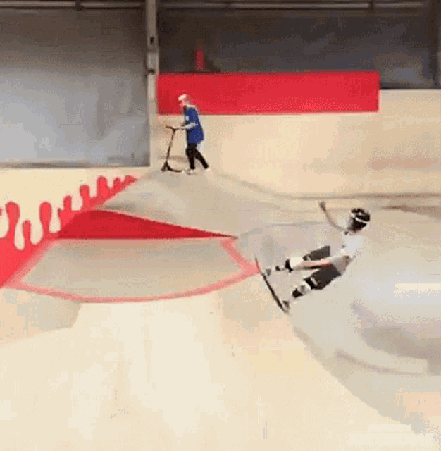 a person riding a scooter on a ramp at a skate park .