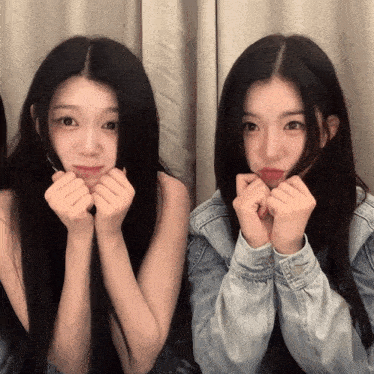 two girls are making faces with their hands