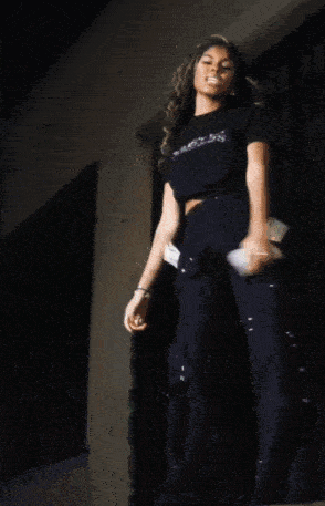 a woman wearing a black t-shirt that says just be jealous