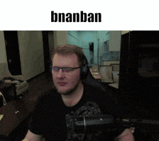 a man wearing glasses and headphones is sitting in front of a microphone with the name bnanban above him