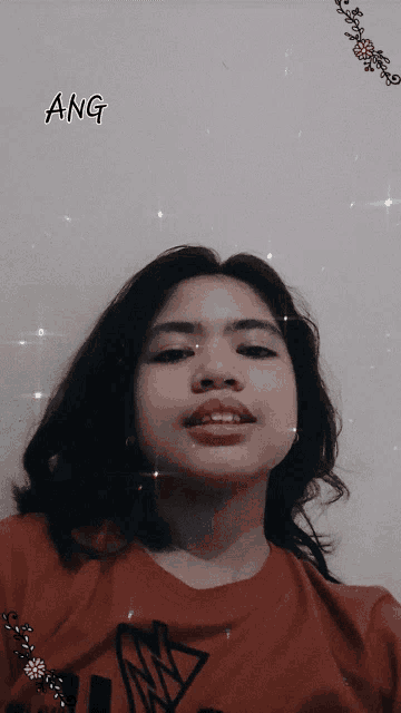 a girl in a red shirt with ang written on the top