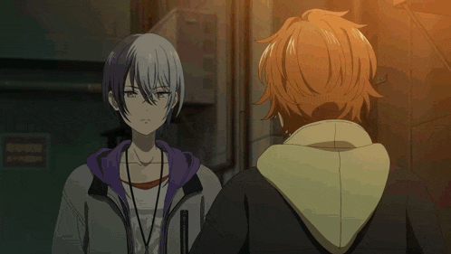 a young anime boy with orange hair and a yellow stripe on his forehead is standing in a dark alleyway .