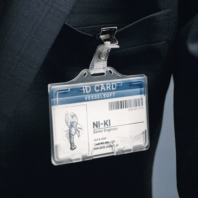 a man in a suit has an id card that says vesselsoft