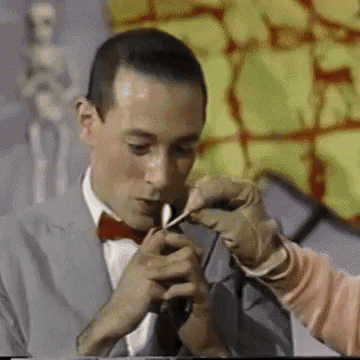 a man in a suit and bow tie is being examined by a doctor