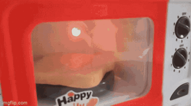 a toy microwave with a sticker that says happy on it