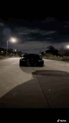a car is driving down a road with a lightning bolt coming out of it .