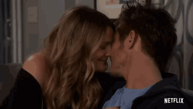 a man and a woman are kissing in a netflix advertisement
