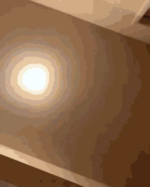 a light is shining on a ceiling with a blurred background