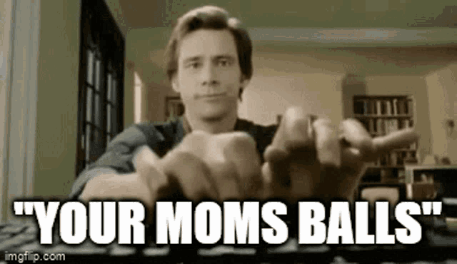 a man is typing on a keyboard with the words `` your moms balls '' written below him .