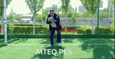 a man on a soccer field with the words mteq pes on the bottom right