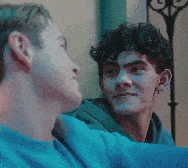 a couple of young men are looking at each other and one of them is saying no .
