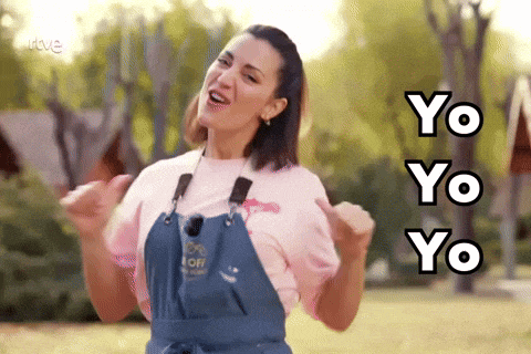 a woman wearing a pink shirt and blue overalls is singing yo yo yo yo