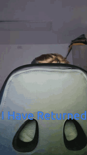 a person sitting in a chair with the words " i have returned " on the bottom