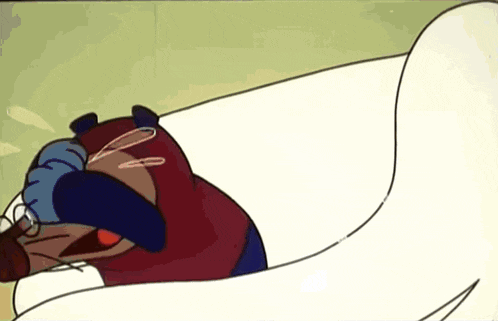a cartoon character is laying on a white couch with his head in his hands
