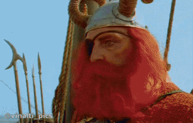 a pixelated image of a man with horns and red hair