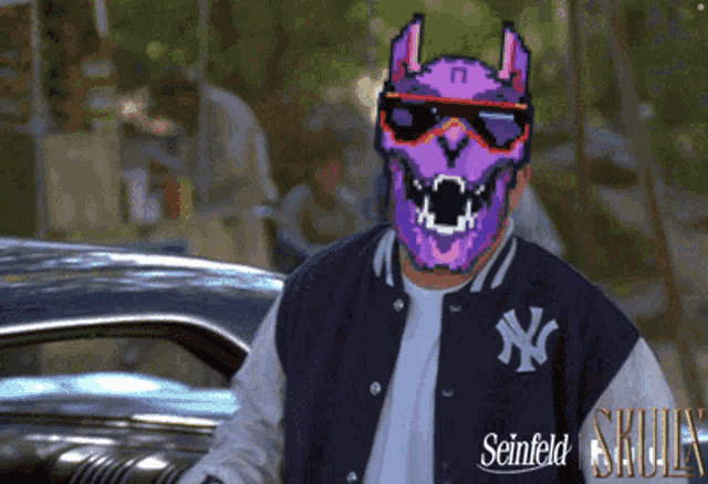 a man wearing a purple mask and a seinfeld jacket stands in front of a car