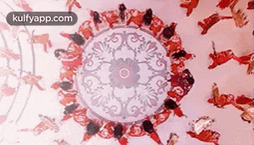 a group of people are dancing in a circle on a pink background .