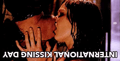 a man and woman kissing in the rain with the words international kissing day below them