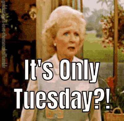 an older woman is standing in front of a window and says it 's only tuesday .