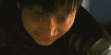 a close up of a person 's face with a tear coming out of it
