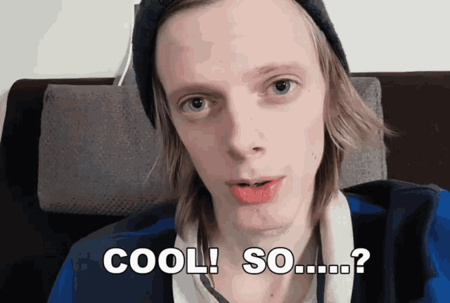a man wearing a beanie and a blue shirt says cool so