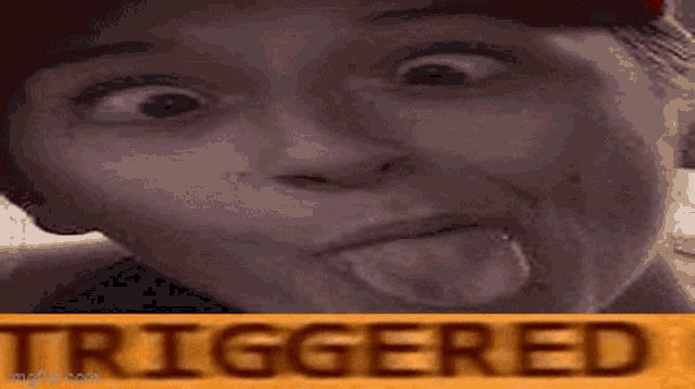 a close up of a person making a funny face with the word triggered in the background