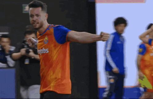 a soccer player wearing an orange and blue jersey that says ' ejobs ' on it