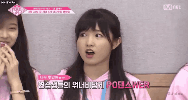 a girl in a pink shirt has a blue lanyard around her neck that says po