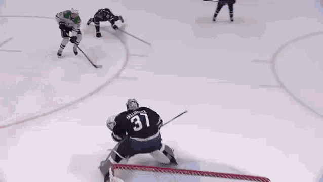a hockey player with the number 4 on his jersey is laying on the ice