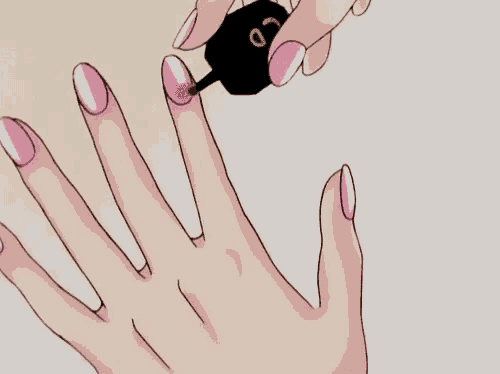 a person is applying pink nail polish to their nails