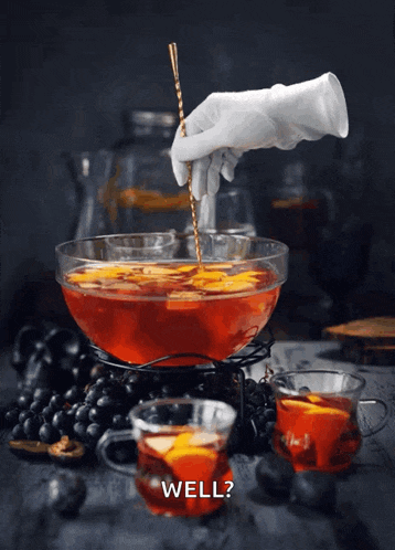 a hand is stirring a punch with a spoon and the words well below it