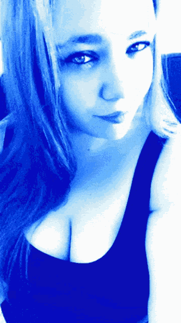 a woman in a black tank top with a blue background