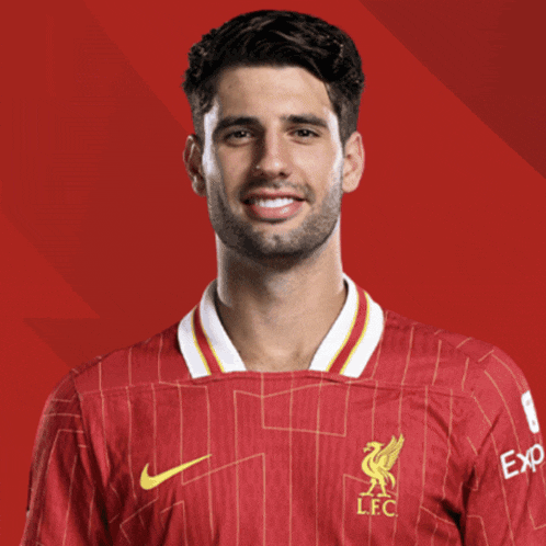 a man is wearing a red jersey with the letters lfc on it