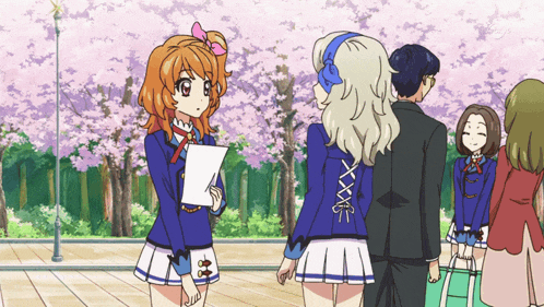 a girl in a blue and white skirt holds a piece of paper