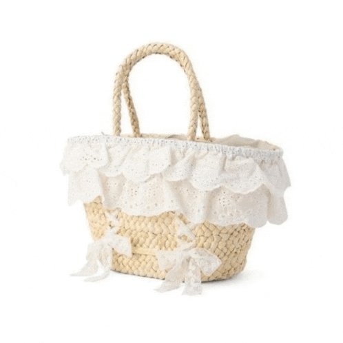 a wicker basket with white lace and bows on the side