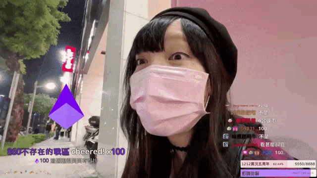 a woman wearing a face mask with a purple triangle in the background that says cheered x 100