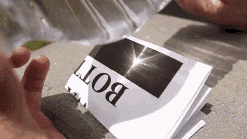 someone is pouring water on a piece of paper that says bot