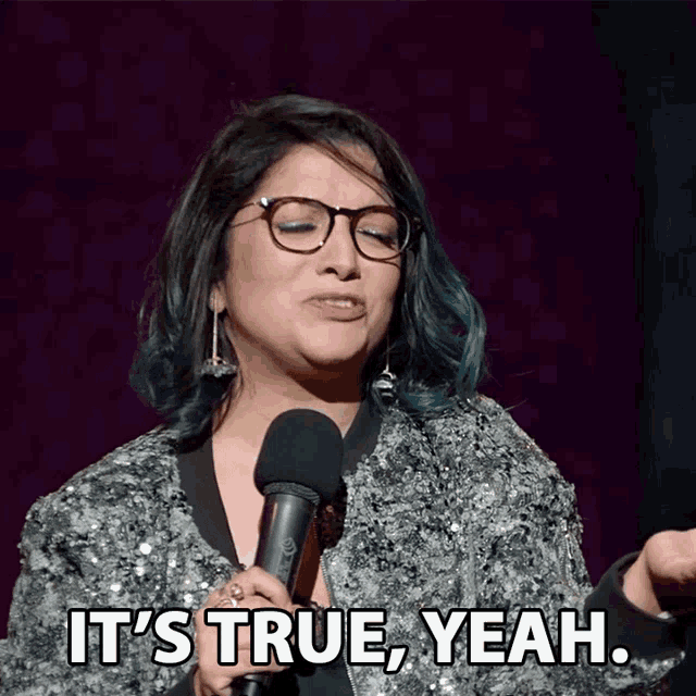 a woman speaking into a microphone with the words it 's true yeah
