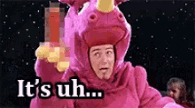 a man in a pink unicorn costume is saying `` it 's uh . ''