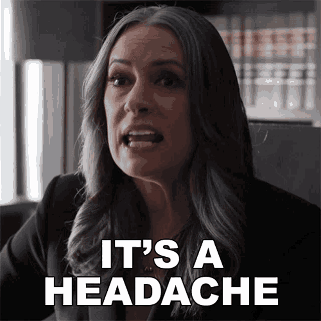a woman says it 's a headache in front of a bookcase
