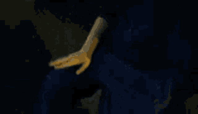 a close up of a person 's hand with a yellow glove on it .